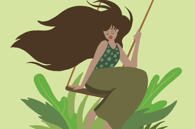 a happy woman with flowy & bouncy hair on a swing