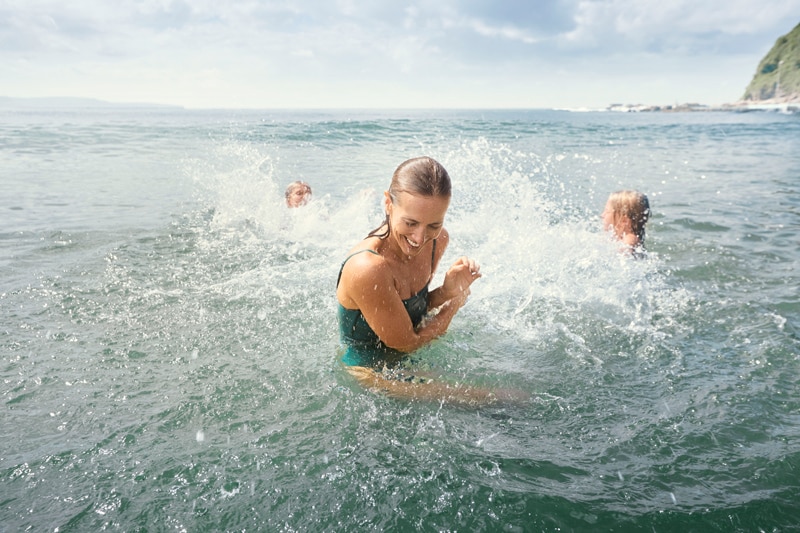 mom and kids playing on the sea